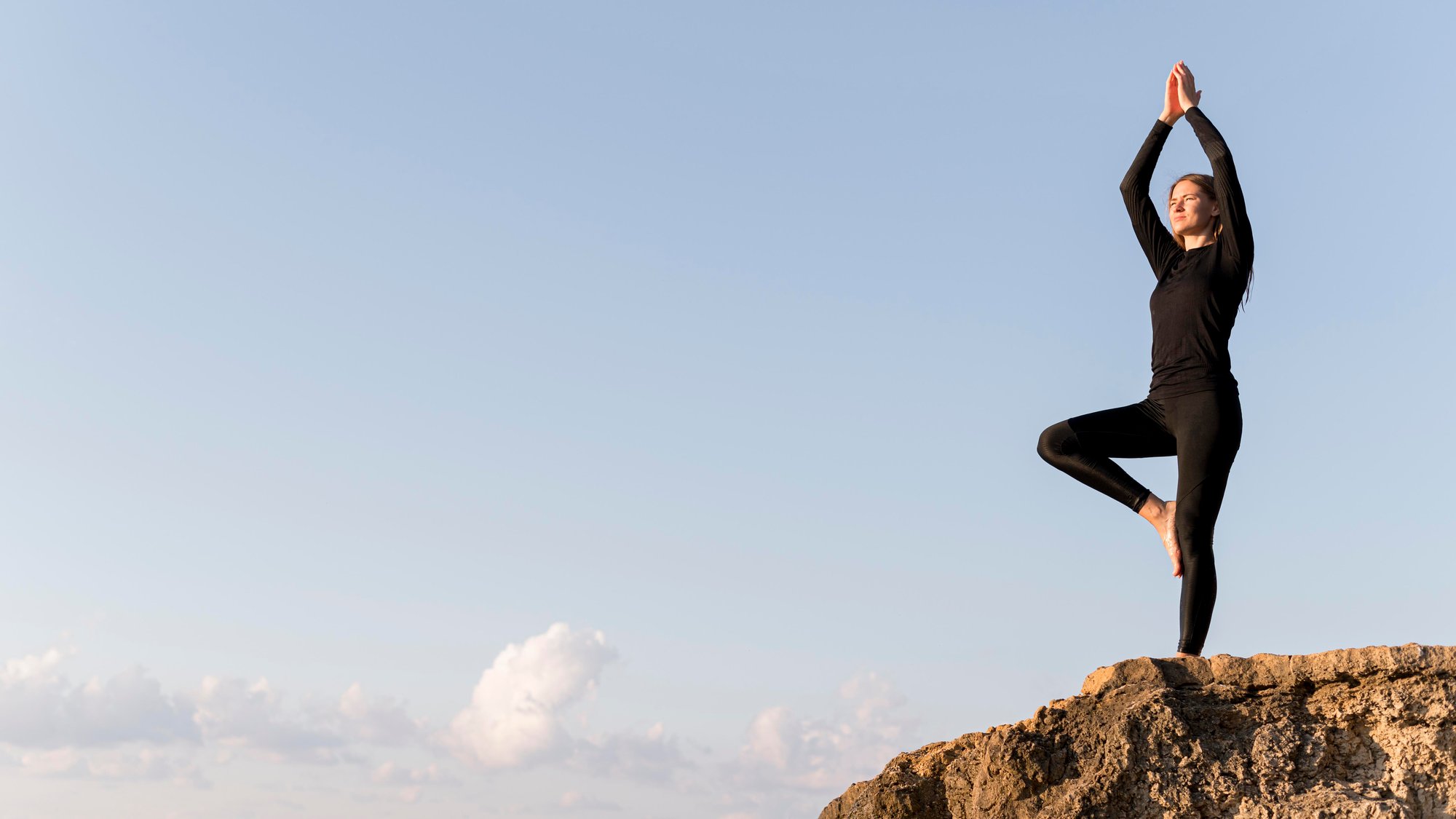 woman-meditating-coast-with-copy-space
